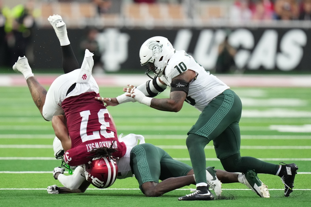 Indiana tight end Riley Nowakowski (37) os tackled by Michigan State defensive back Malcolm Bell (14) and linebacker Wayne Matthews (10) during the second half of an NCAA college football game, Saturday, Oct. 18, 2025, in Bloomington, Ind. (AP Photo/AJ Mast)