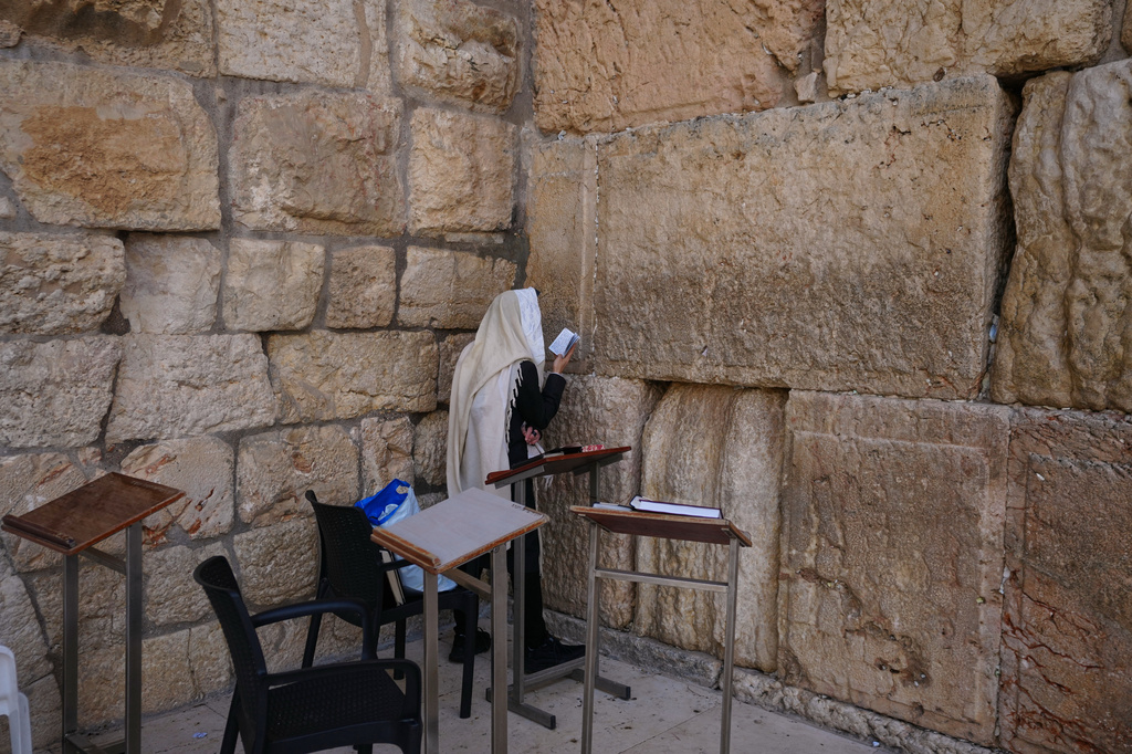 An Ultra-Orthodox Jewish man prays at the Western Wall, the holiest site where Jews can pray, after restrictions were lifted following a ceasefire reached between Iran, Israel and the United States, in the Old City of Jerusalem, Thursday, April 9, 2026. (AP Photo/Mahmoud Illean)