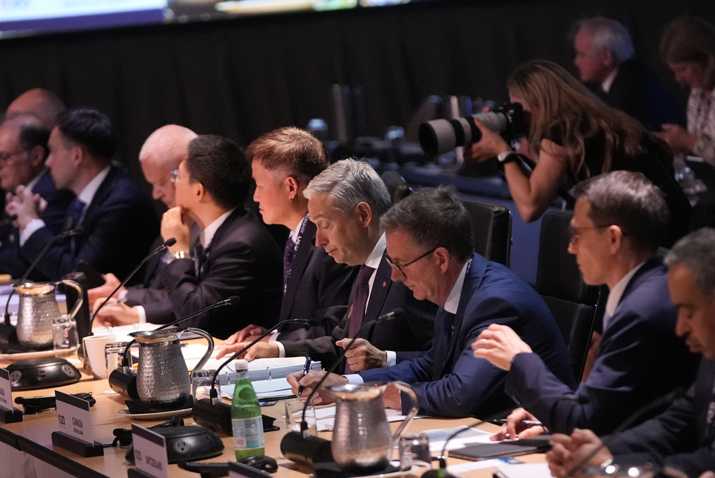 Canadian Finance Minister Francois-Philippe Champagne, center, listens during the Plenary Session of Current Economic Developments at the G20 Finance Ministerial in Asheville, N.C., Monday, Aug. 31, 2026. (AP Photo/Gerald Herbert)