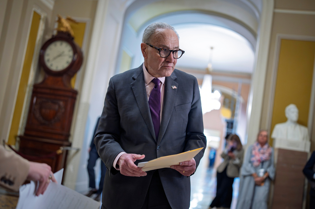Senate Minority Leader Chuck Schumer, D-N.Y., goes over his notes before speaking to reporters following a closed-door party meeting, at the Capitol in Washington, Tuesday, April 21, 2026. (AP Photo/J. Scott Applewhite)
