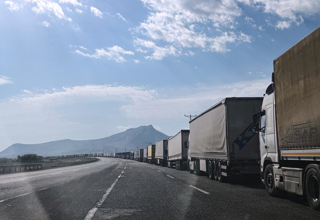 Trucks queue on the road leading to the Gurbulak border crossing on the Turkish-Iranian border in Agri province, eastern Turkey, Tuesday, Sept. 22, 2026. (AP Photo/Serra Yedikardes)