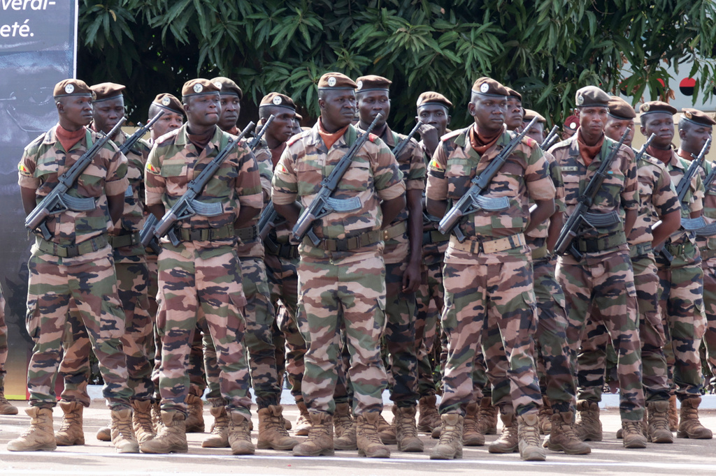 Soldiers wait for the start of the funeral for Mali's former defense minister Sadio Camara at the Military Engineering Parade Ground in Bamako, Mali, Thursday, April 30, 2026. (AP Photo/Boubacary Bocoum)