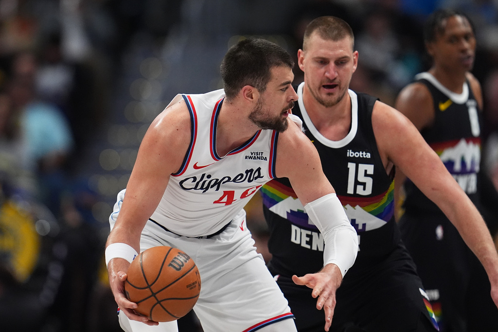 Los Angeles Clippers center Ivica Zubac, left, looks to pass the ball as Denver Nuggets center Nikola Jokić (15) defends in the first half of an NBA basketball game Friday, Jan. 30, 2026, in Denver. (AP Photo/David Zalubowski)