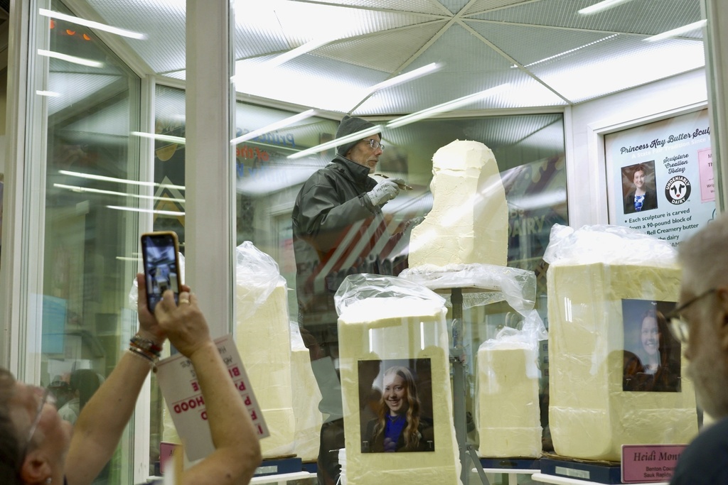 Sculptor Gerry Kulzer carves the likeness of Malorie Thorson, this year's Princess Kay of the Milky Way, out of a block of butter at the Minnesota State Fair, Thursday, Aug. 21, 2025 in Falcon Heights, Minn. (AP Photo/Mark Vancleave)