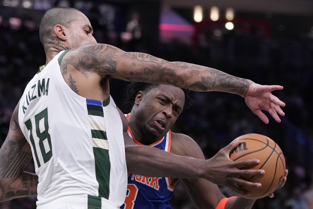 Milwaukee Bucks' Kyle Kuzma fouls New York Knicks' OG Anunoby during the first half of an NBA basketball game Tuesday, Oct. 28, 2025, in Milwaukee. (AP Photo/Morry Gash)