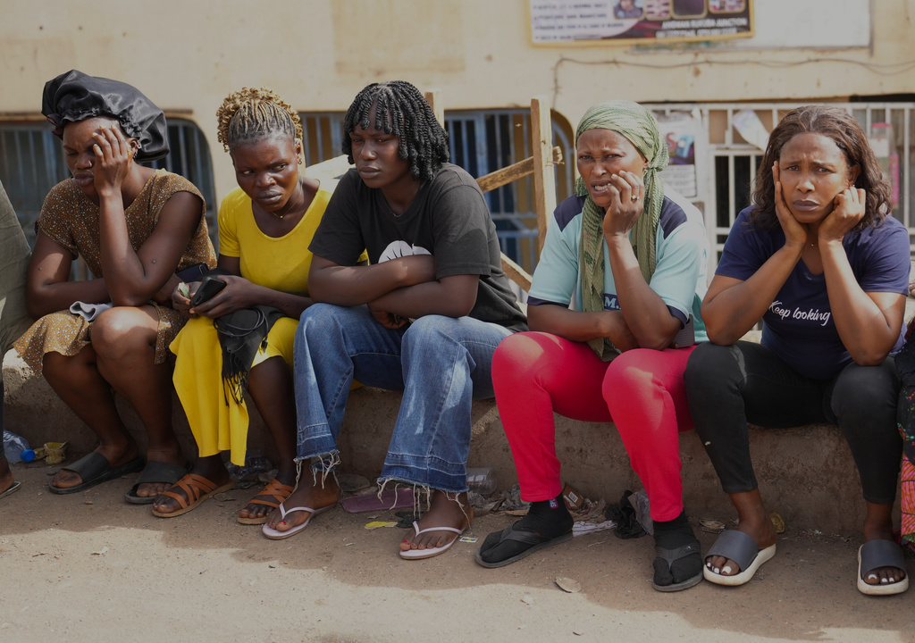 Women mourn following an attack by gunmen in Gari Ya Waye community in Jos North Nigeria, Monday, March 30, 2026. (AP Photo/Samson Omale)