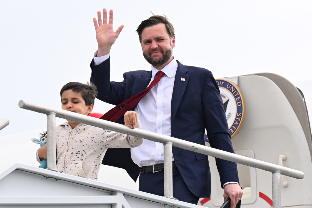 Vice President JD Vance and his son Vivek, walk off Air Force Two upon arrival at Cincinnati/Northern Kentucky International Airport in Hebron, Ky., Tuesday, May 5, 2026. Vance is stopping in Ohio to vote in the state's primary election before continuing on to Oklahoma and Iowa. (Roberto Schmidt /Pool Photo via AP)