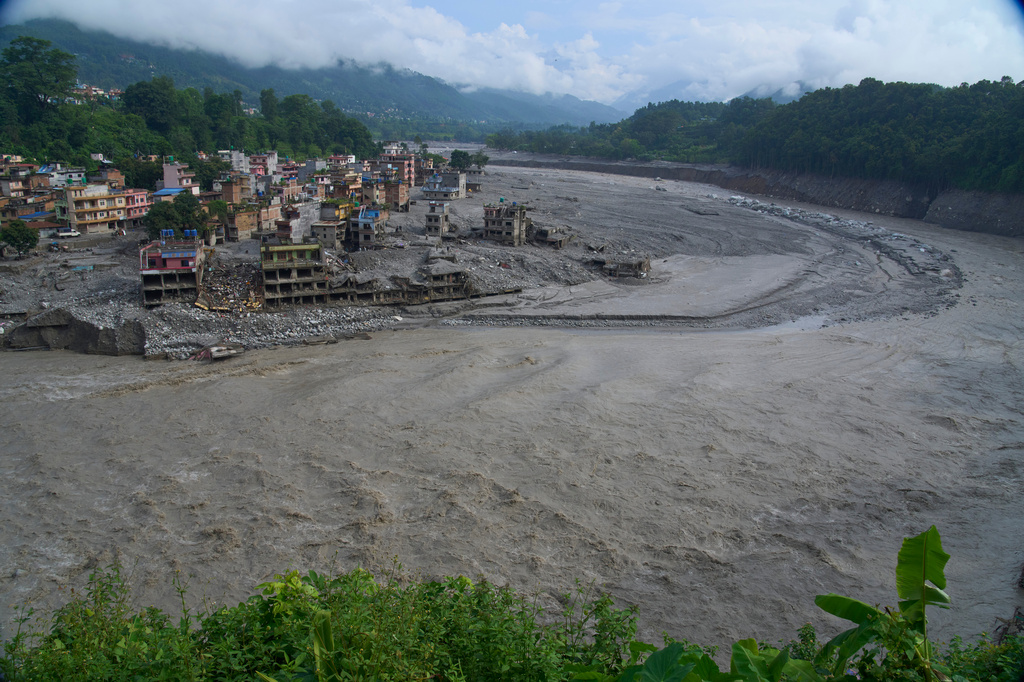 Houses damaged by flash floods are seen on the bank of Trishuli river in Dhunge, Nuwakot district, Nepal, Monday, Sept. 7, 2026. (AP Photo/Niranjan Shrestha)