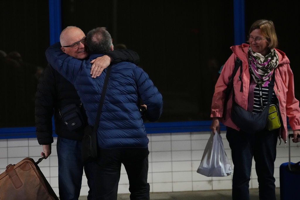 People arrive at the airport after being evacuated from the Middle East on a government flight, in Prague, Czech Republic, Tuesday, March 3, 2026. (AP Photo/Petr David Josek)