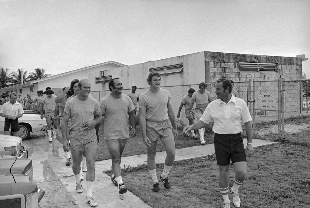 FILE - Miami Dolphins football coach Don Shula, right, leads, from left, safety Dick Anderson, defensive tackle Manny Fernandez and defensive end Bill Stanfield, to the practice field on July 11, 1973 in Miami, for the first day of workouts for the 1973 season.( AP Photo/Jim Kerlin, File)