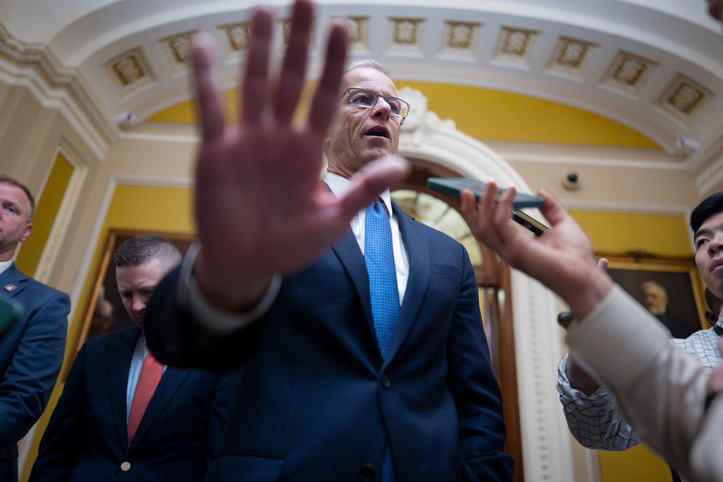 Senate Majority Leader John Thune, R-S.D., gestures as he speaks to reporters outside the chamber after passing a a measure by unanimous consent that would fund most of the Department of Homeland Security if the House agrees, at the Capitol in Washington, Thursday, April 2, 2026. (AP Photo/J. Scott Applewhite)