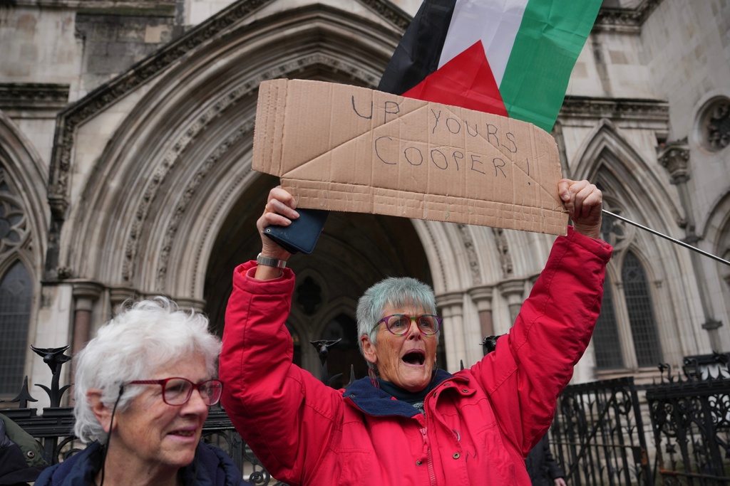 Supporters of Palestine Action stage a protest outside the Royal Court of Justice in London, Friday, Feb. 13, 2026. (AP Photo/Kin Cheung)