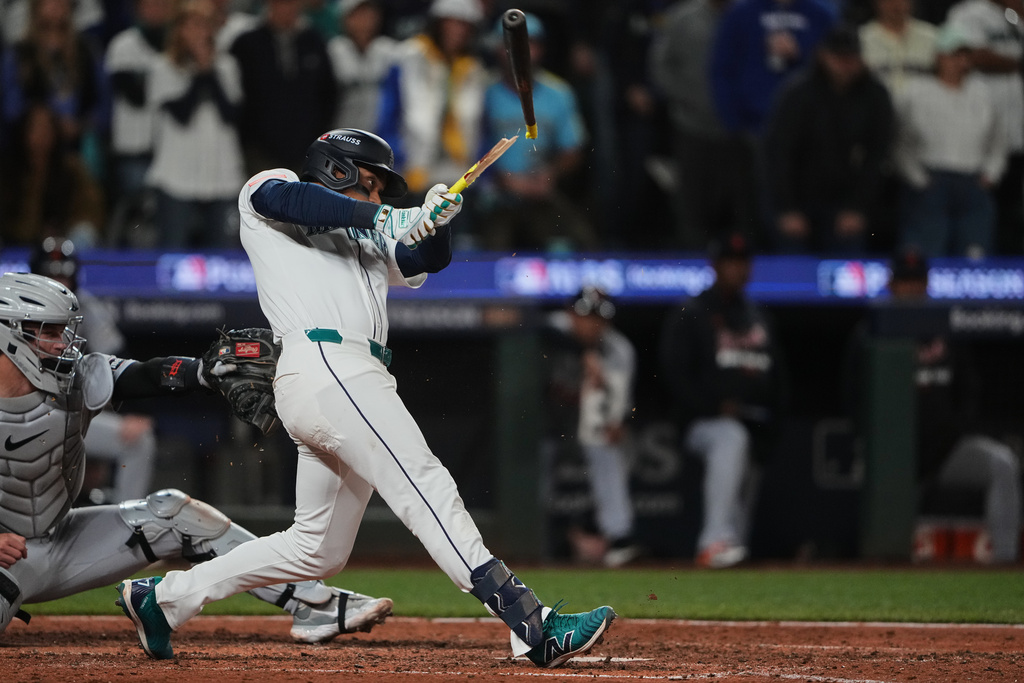 Seattle Mariners' Jorge Polanco breaks his bat on a single during the eighth inning in Game 2 of baseball's American League Division Series against the Detroit Tigers, Sunday, Oct. 5, 2025, in Seattle. (AP Photo/Lindsey Wasson)