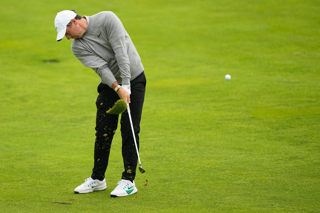 Rory McIlroy, of Northern Ireland, hits from the fairway on the 14th hole during the first round of the U.S. Open golf tournament at Shinnecock Hills Golf Club in Southampton, N.Y., Thursday, June 18, 2026.(AP Photo/Gerald Herbert)