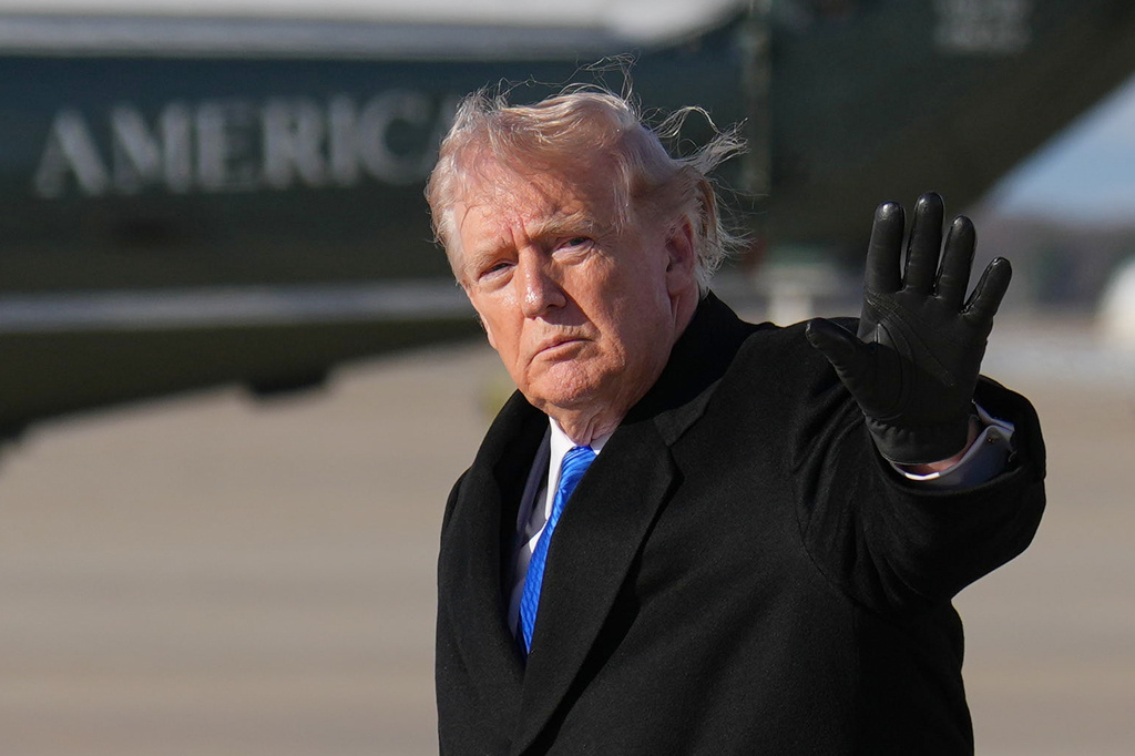 President Donald Trump waves after arriving on Air Force One, Monday, March 23, 2026, at Joint Base Andrews, Md. (AP Photo/Mark Schiefelbein)
