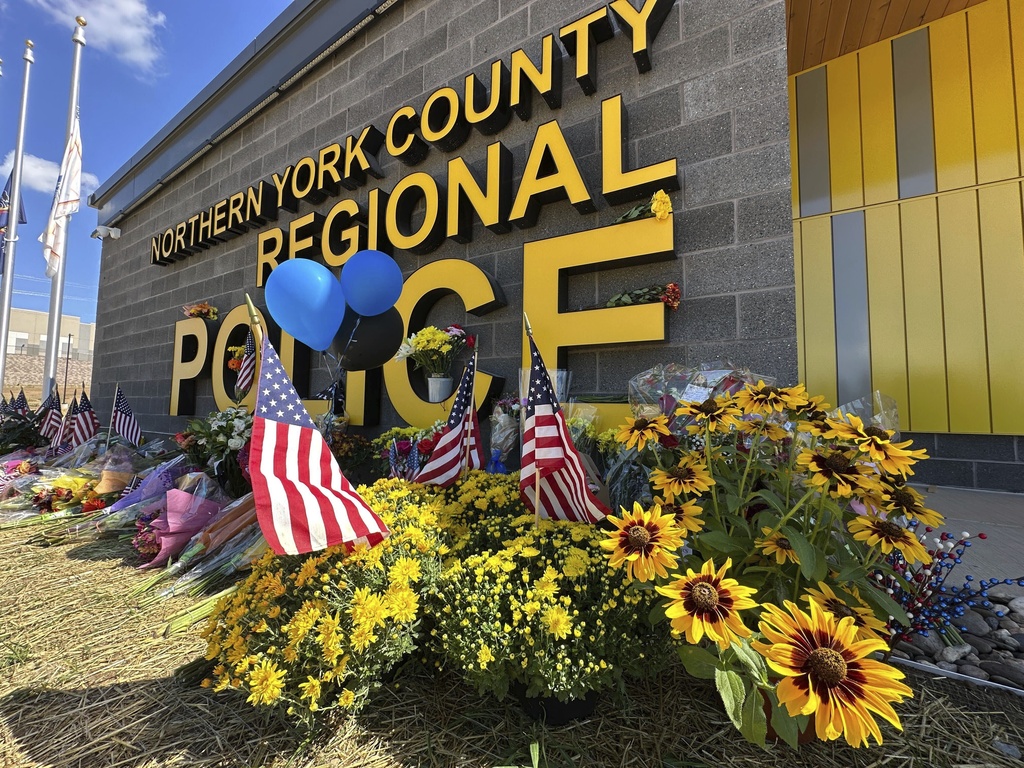 A memorial for police officers killed in a shooting is shown outside the Northern York County Regional Police Department, Thursday, Sept. 18, 2025 in York, Pa. (AP Photo/Tassanee Vejpongsa)