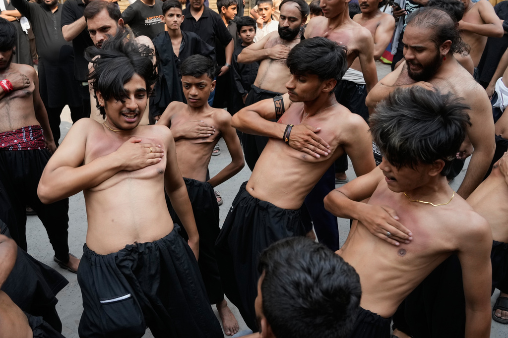 Shiite Muslims beat their chests in a ritual during a gathering in the mourning month of Muharram, in Lahore, Pakistan, Wednesday, Jun 24, 2026. (AP Photo/K.M. Chaudary)