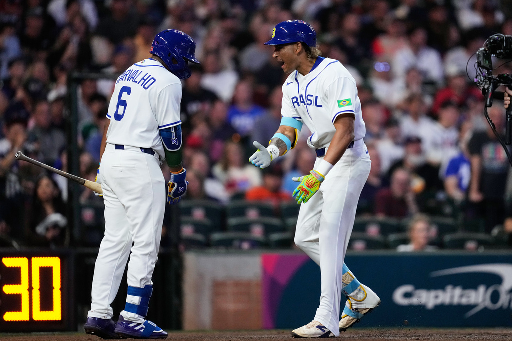 Brazil's Lucas Ramirez, right, celebrates with Osvaldo Carvalho after hitting a solo home run during the first inning of a World Baseball Classic game against the United States, Friday, March 6, 2026, in Houston. (AP Photo/Ashley Landis)