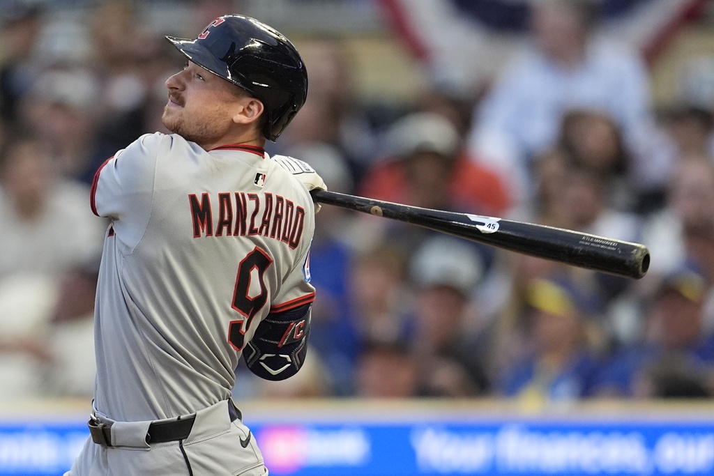 Cleveland Guardians' Kyle Manzardo (9) hits a single against the Minnesota Twins in the third inning of the second baseball game of a doubleheader, Saturday, Sept. 20, 2025, in Minneapolis. (AP Photo/Mike Stewart)
