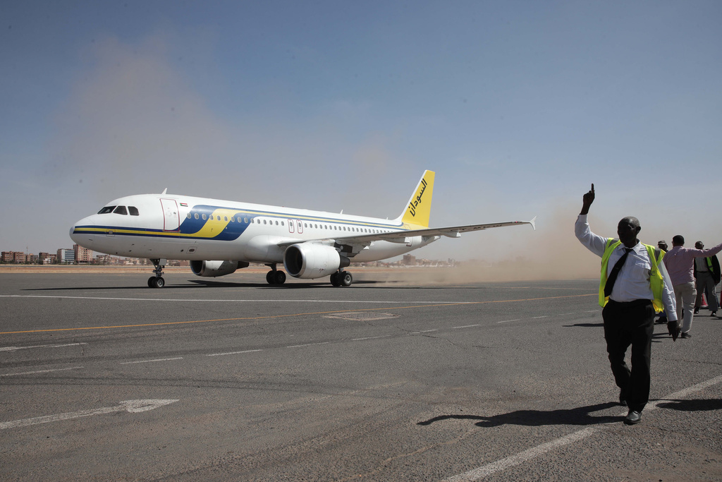 Khartoum International Airport ground workers greet the first domestic Sudan Airways flight landing from Port Sudan, following the war between Sudan's army and the paramilitary Rapid Support Forces, in Khartoum, Sudan, Sunday, Feb. 1, 2026. (AP Photo/Marwan Ali)