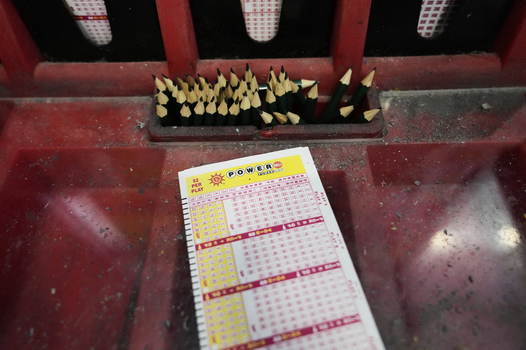 A Powerball play slip sits on the lottery ticket counter at a gas station, Friday, Aug. 29, 2025, in Baltimore. (AP Photo/Stephanie Scarbrough)