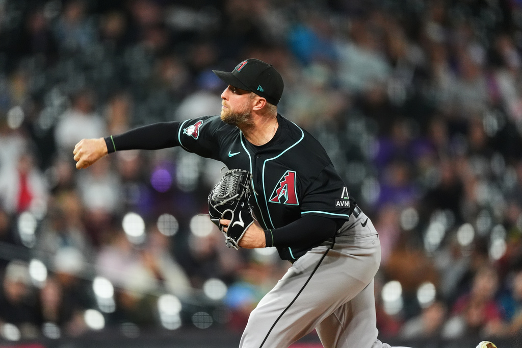 Arizona Diamondbacks starting pitcher Merrill Kelly works against the Colorado Rockies in the second inning of a baseball game Wednesday, Sept. 23, 2026, in Denver. (AP Photo/David Zalubowski)
