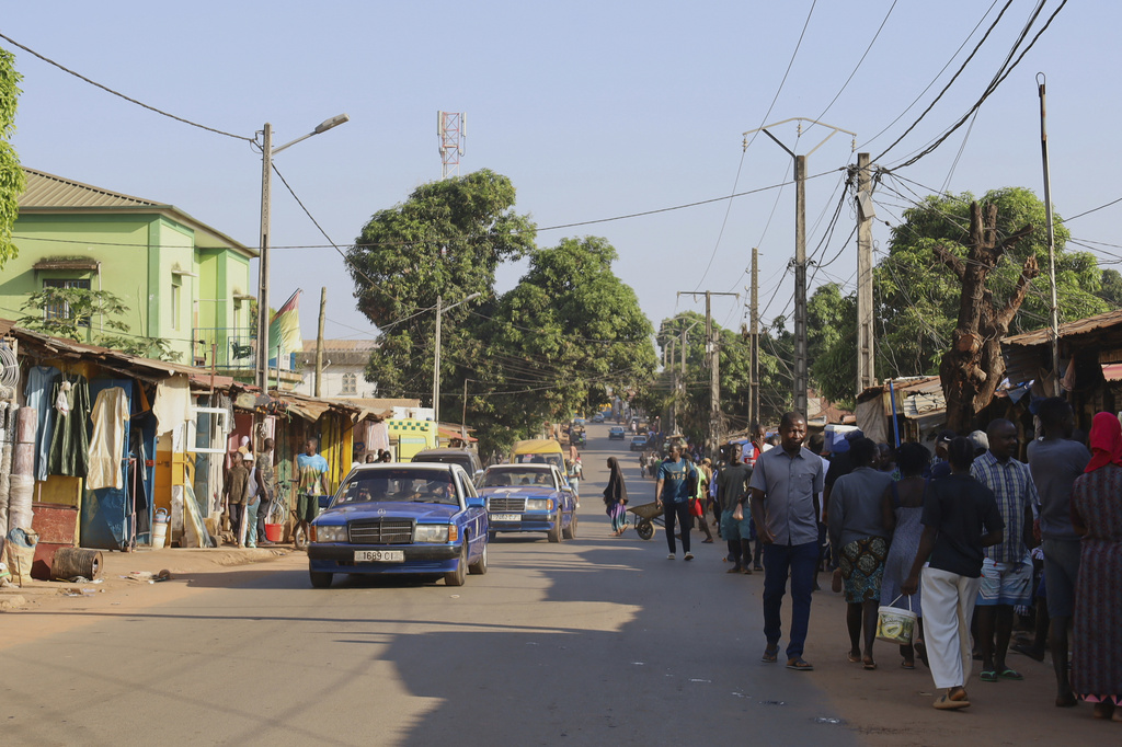 People walk along a street in Bissau, Guinea-Bissau, Friday, Nov. 28, 2025. (AP Photo/Darcicio Barbosa)