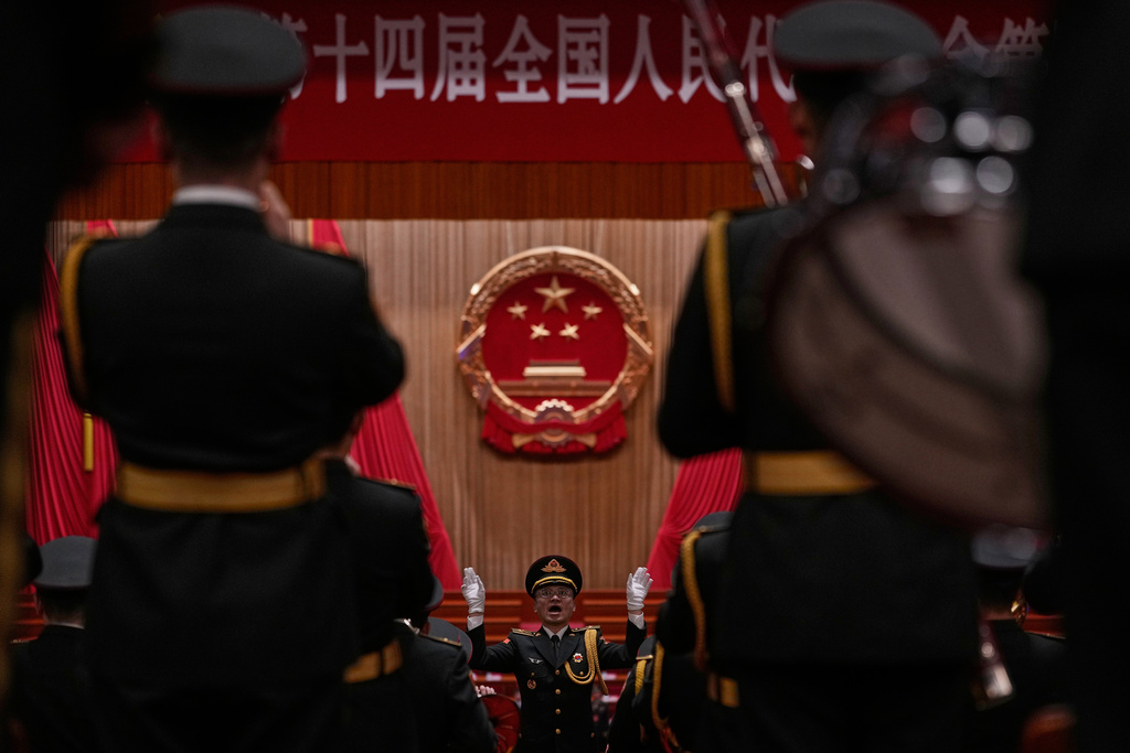 A Chinese military conductor gestures as he instructs his music band members during a rehearsal for the closing session of the National People's Congress (NPC) at the Great Hall of the People, in Beijing, China, Thursday, March 12, 2026. (AP Photo/Andy Wong)