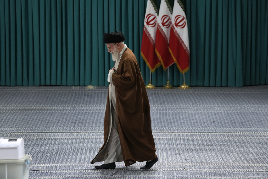 FILE - Iranian Supreme Leader Ayatollah Ali Khamenei arrives to vote for the parliamentary runoff elections, in Tehran, Iran, May 10, 2024. (AP Photo/Vahid Salemi, File)