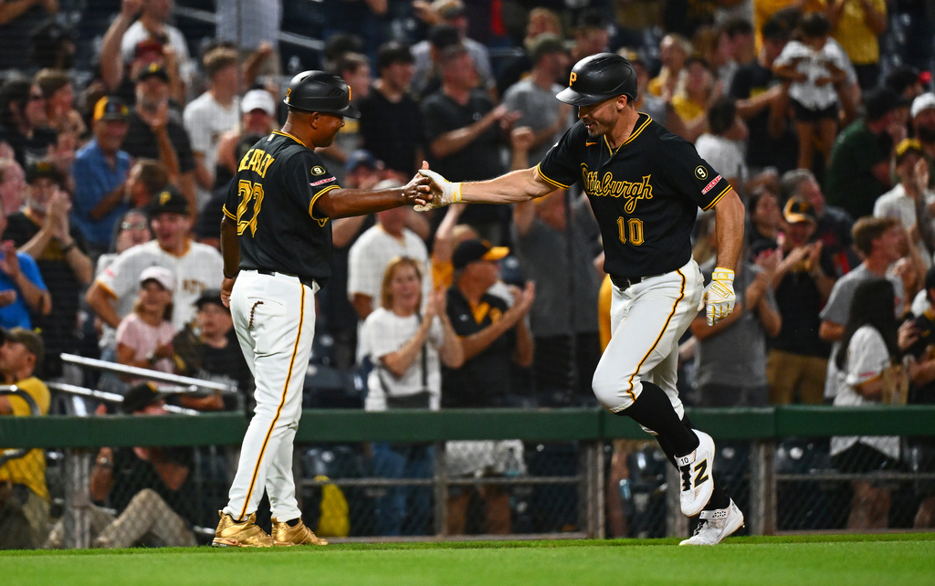 Pittsburgh Pirates' Bryan Reynolds celebrates with third base coach Tony Beasley after hitting a solo home run off of Arizona Diamondbacks pitcher Paul Sewald during the ninth inning of a baseball game in Pittsburgh, Tuesday, July 28, 2026. (AP Photo/Justin Berl)