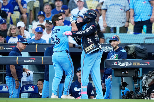 Toronto Blue Jays' Davis Schneider celebrates a home run against the Los Angeles Dodgers during the first inning in Game 5 of baseball's World Series, Wednesday, Oct. 29, 2025, in Los Angeles. (AP Photo/Brynn Anderson) Toronto Blue Jays' Davis Schneider celebrates a home run against the Los Angeles Dodgers during the first inning in Game 5 of baseball's World Series, Wednesday, Oct. 29, 2025, in Los Angeles. (AP Photo/Brynn Anderson)