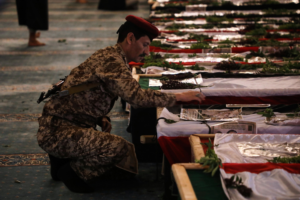 A Houthi officer mourns over a coffin of one of 31 local journalists reportedly killed in Israeli airstrikes last week, during their funeral inside the Shaab Mosque in Sanaa, Yemen, Tuesday, Sept. 16, 2025. (AP Photo/Osamah Abdulrahman)