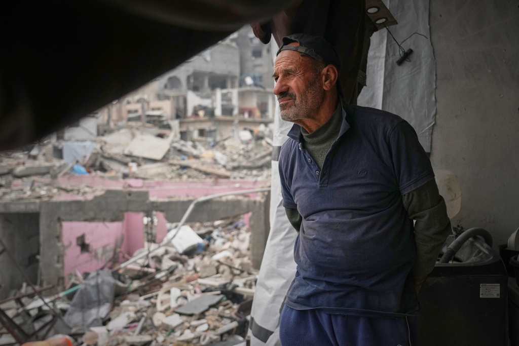 Khaled Nassar looks over the destruction at his apartment in the Jabaliya refugee camp in Gaza City Feb. 9, 2025. Nassar's daughter, Dalia, and his son, Mahmoud, were killed in separate airstrikes, leaving both buried under their homes. (AP Photo/Abdel Kareem Hana)