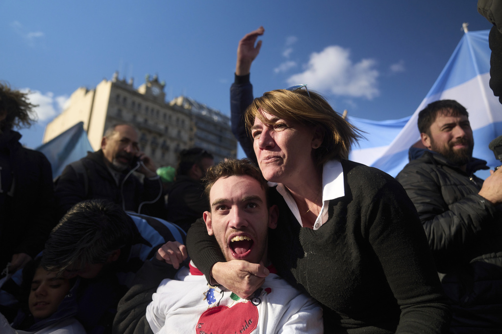 Miriam Espinosa celebrates with his son Matias Ramon Day, after senators rejected President Javier Milei's veto of a bill to expand protections for people with disabilities, in Buenos Aires, Argentina, Thursday, Sept. 4, 2025. (AP Photo/Victor R. Caivano)
