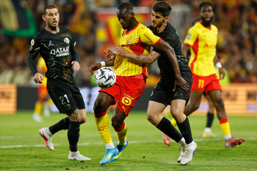 Lens' Abdallah Sima, center left, and PSG's Lucas Beraldo, center right, vie for the ball during the French League One soccer match between Lens and Paris Saint Germain, in Lens, northern France, Wednesday, May 13, 2026. (AP Photo/Jean-Francois Badias)