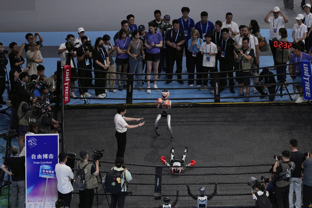 Robots participate in the Free Combat event at the World Humanoid Robot Games held in Beijing, China, Friday, Aug. 15, 2025. (AP Photo/Mahesh Kumar A.)