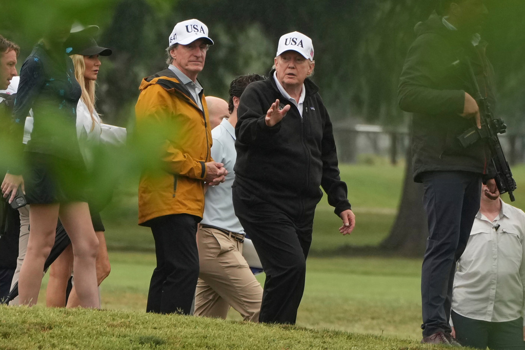 FILE - President Donald Trump, right, and Interior Secretary Doug Burgum tour the East Potomac Park golf course, June 28, 2026, in Washington. (AP Photo/Mark Schiefelbein, File)
