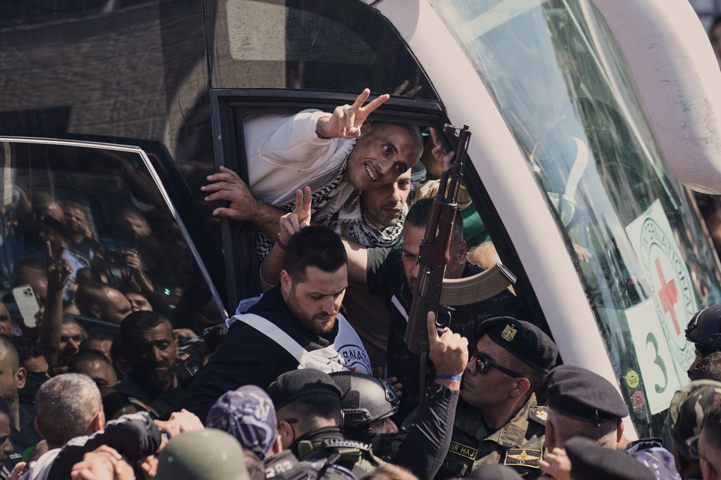 A Palestinian prisoner makes the victory sign after being released from an Israeli prison as part of a ceasefire deal between Israel and Hamas, upon his arrival in the West Bank city of Ramallah, Monday, Oct. 13, 2025. (AP Photo/Majdi Mohammed)