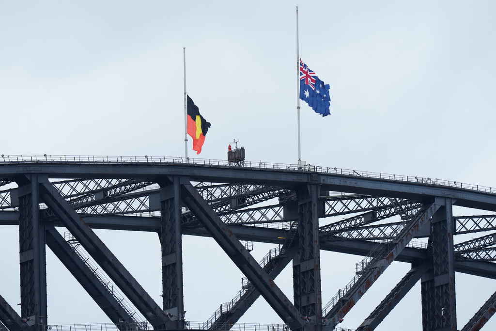 The Australian and Aboriginal flags are at half-staff ahead of a National Day of Mourning event in Sydney, Thursday, Jan. 22, 2026, in remembrance of the 15 people shot dead at a Jewish festival in Sydney last month. (AP Photo/Rick Rycroft)