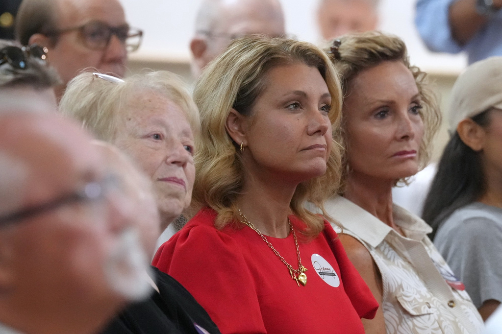 Jenny Costa Honeycutt, center, Republican nominee in South Carolina's 1st District, listens to speakers at a campaign event for Republican candidates vying in a special GOP primary to replace Sen. Lindsey Graham, R-S.C., Thursday, Aug. 6, 2026, in Charleston, S.C. (AP Photo/Meg Kinnard)