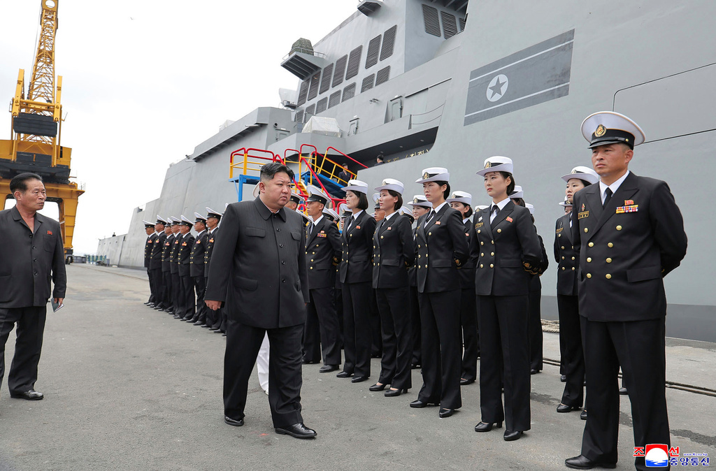In this photo provided by the North Korean government, North Korean leader Kim Jong Un, center, the warship Choe Hyon in Nampo, North Korea, on Aug. 18, 2025. Independent journalists were not given access to cover the event depicted in this image distributed by the North Korean government. The content of this image is as provided and cannot be independently verified. Korean language watermark on image as provided by source reads: "KCNA" which is the abbreviation for Korean Central News Agency. (Korean Central News Agency/Korea News Service via AP)
