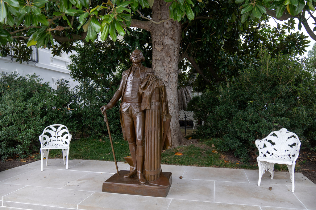 FILE - A bronze statue of President George Washington is seen at the edge of the Rose Garden at the White House in Washington, Oct. 12, 2025. (AP Photo/Mark Schiefelbein, File)