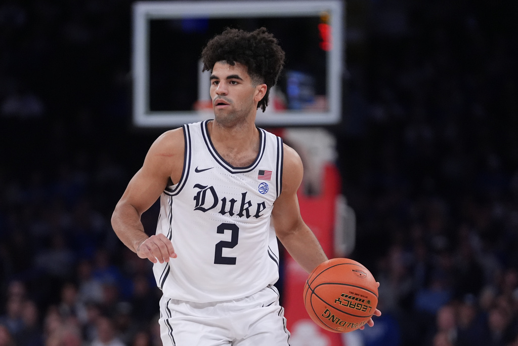Duke's Cayden Boozer (2) looks to pass during the first half of an NCAA college basketball game against Kansas Tuesday, Nov. 18, 2025, in New York. (AP Photo/Frank Franklin II)