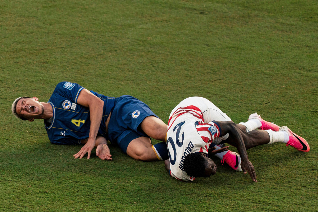 United States' Folarin Balogun (20) and Bosnia's Tarik Muharemovic (4) react after Balogun fouled Muharemovic during the World Cup round of 32 soccer match between the United States and Bosnia in Santa Clara, Calif., near San Francisco, Wednesday, July 1, 2026. Balogun received a red card on the play. (Stephen Lam/San Francisco Chronicle via AP)