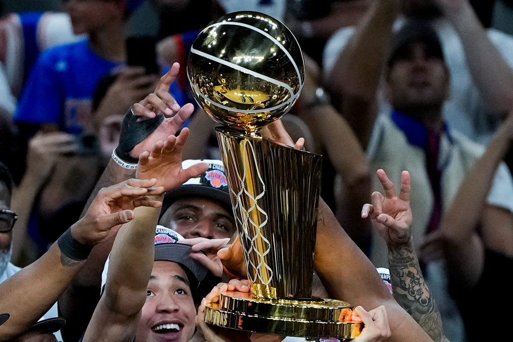 The New York Knicks celebrate with the Larry O'Brien Championship Trophy after defeating the San Antonio Spurs in Game 5 of the NBA Finals basketball series, Saturday, June 13, 2026, in San Antonio. (AP Photo/Ross D. Franklin)
