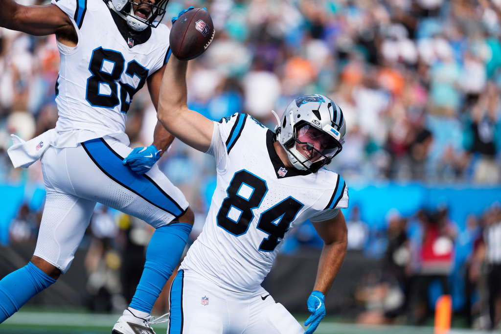 Carolina Panthers tight end Mitchell Evans celebrates after scoring against the Miami Dolphins during the second half of an NFL football game, Sunday, Oct. 5, 2025, in Charlotte, N.C. (AP Photo/Jacob Kupferman)