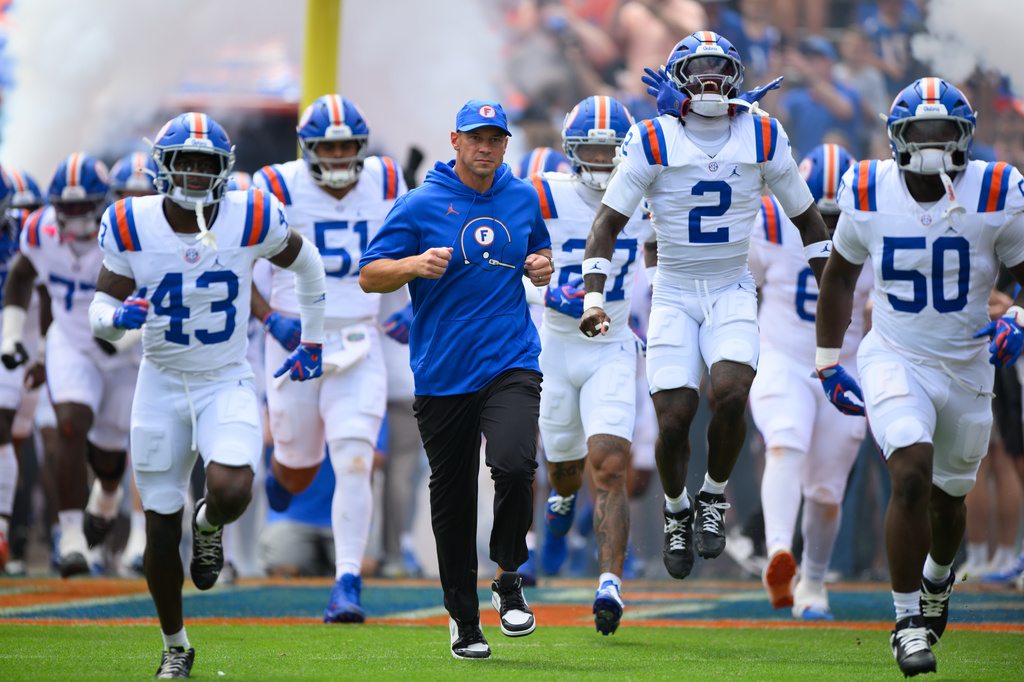 Florida head coach Jon Sumrall leads his team onto the field before an NCAA college football game against South Carolina, Saturday, Oct. 10, 2026, in Gainesville, Fla. (AP Photo/Noah Lantor)