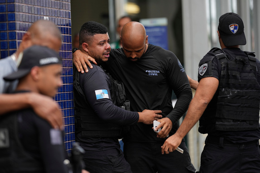 Police gather outside the Getulio Vargas Hospital where a colleague was brought after getting injured in an operation against alleged drug traffickers in the Complexo do Alemao favela where the criminal organization "Comando Vermelho" operates in Rio de Janeiro, Tuesday, Oct. 28, 2025. (AP Photo/Silvia Izquierdo) Police gather outside the Getulio Vargas Hospital where a colleague was brought after getting injured in an operation against alleged drug traffickers in the Complexo do Alemao favela where the criminal organization "Comando Vermelho" operates in Rio de Janeiro, Tuesday, Oct. 28, 2025. (AP Photo/Silvia Izquierdo)