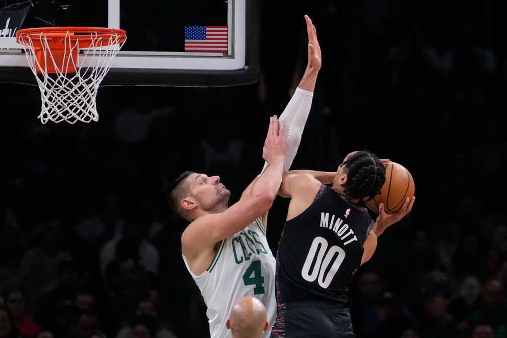 Boston Celtics center Nikola Vucevic (4) tries to block a shot by Brooklyn Nets forward Josh Minott (00) during the first half of an NBA basketball game, Friday, Feb. 27, 2026, in Boston. (AP Photo/Charles Krupa)