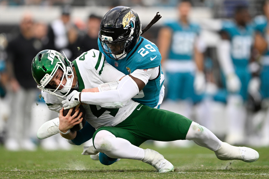 Jacksonville Jaguars safety Eric Murray (29) sacks New York Jets quarterback Brady Cook (4) during the second half of an NFL football game Sunday, Dec. 14, 2025, in Jacksonville, Fla. (AP Photo/Phelan M. Ebenhack)